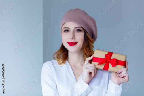 woman in beret with Christmas gift