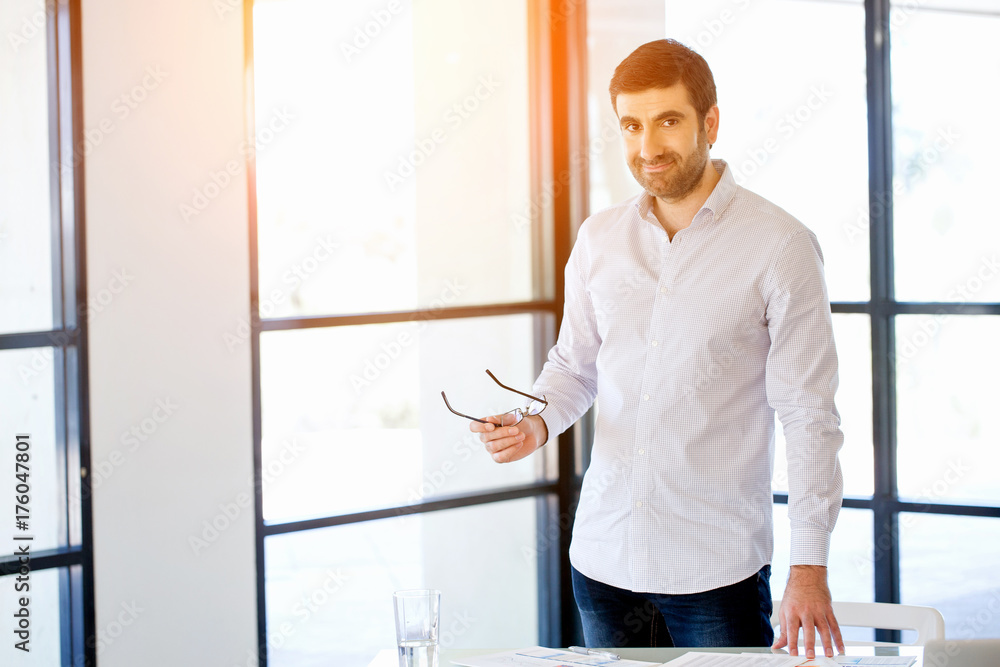 Young caucasian businessman standing in office