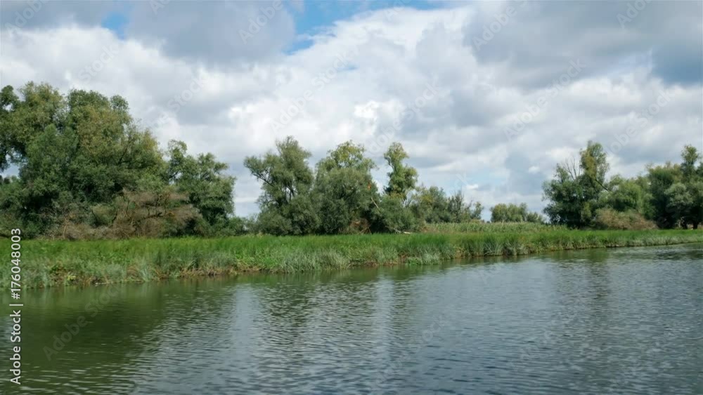 Driving with boat on calm water of nature park Kopacki rit in Croatia on sunny day Driving with boat on calm water of nature park Kopacki rit in Croatia on sunny day