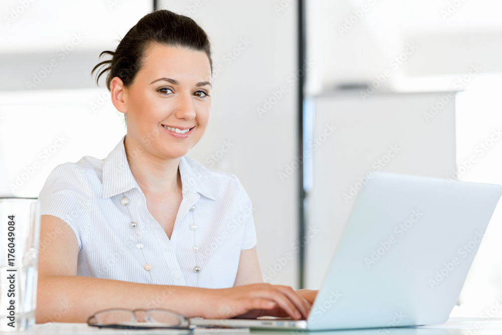 Portrait of businesswoman working at computer in office Portrait of businesswoman working at computer in office
