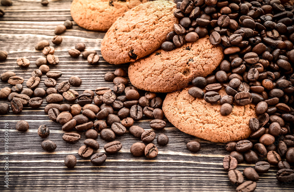 fresh Oatmeal Cookies and coffee beans on wooden background