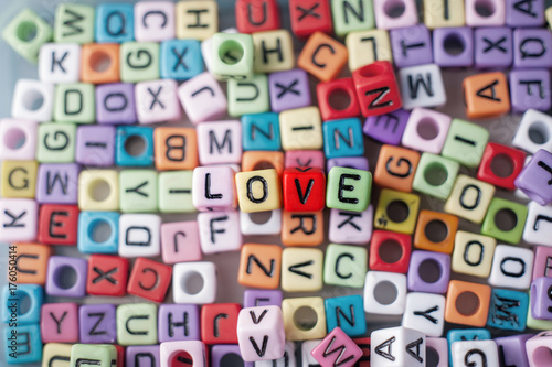 Close up shot of the colorful alphabet beads selective focus on beads forming word LOVE.
