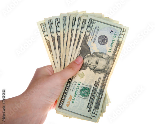 Young female hand holding stack of twenty dollar bills fanned out isolated on white background.
