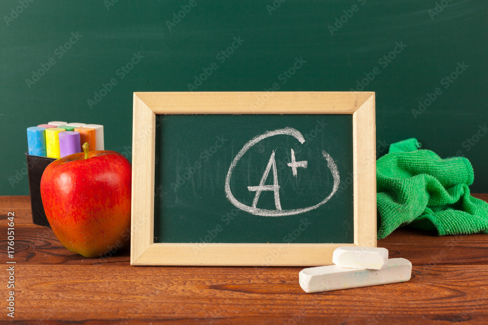 back to school - apple and books with pencils and blackboard