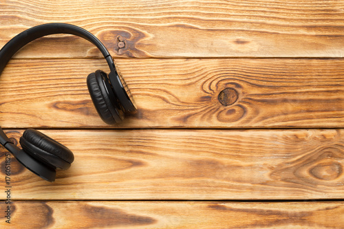 Stereo headphones on wooden background