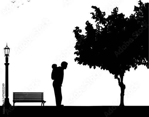 Father carrying a child piggyback on the street, one in the series of similar images silhouette