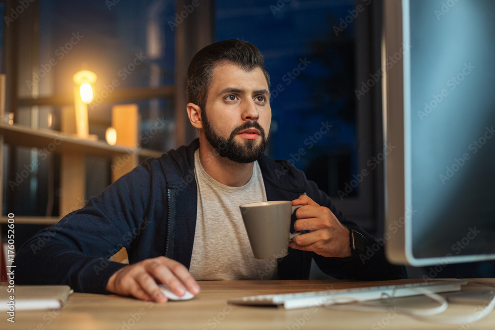 Concentrated brunette being at work in the evening Concentrated brunette being at work in the evening