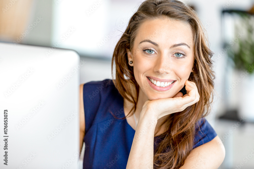 Portrait of businesswoman working at her desk in office