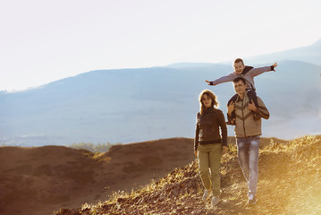 Happy family walking nature mountains area