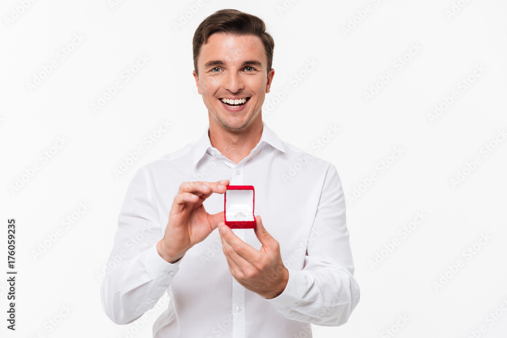 Portrait of happy young man showing open box Portrait of happy young man showing open box