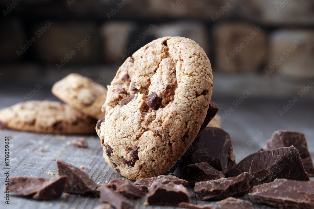 Fototapeta premium Chocolate cookies on wooden table. Chocolate chip cookies shot.