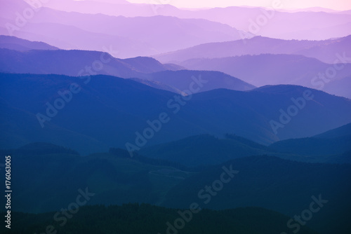 Carpathian mountains summer sunset landscape with abstract gradient of mountain peaks in blue colors, natural travel outdoor background