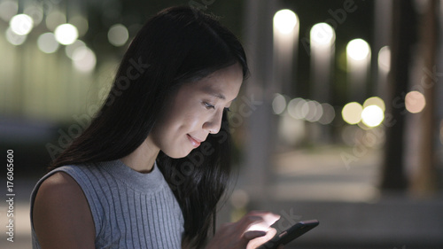 Photography Woman using cellphone at night