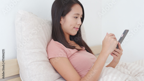 Young Woman use of cellphone on bed