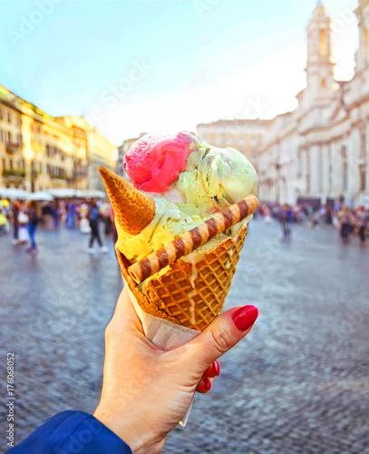 Photography Italian ice - cream cone held in hand on the background of Piazza Navona in Rome
