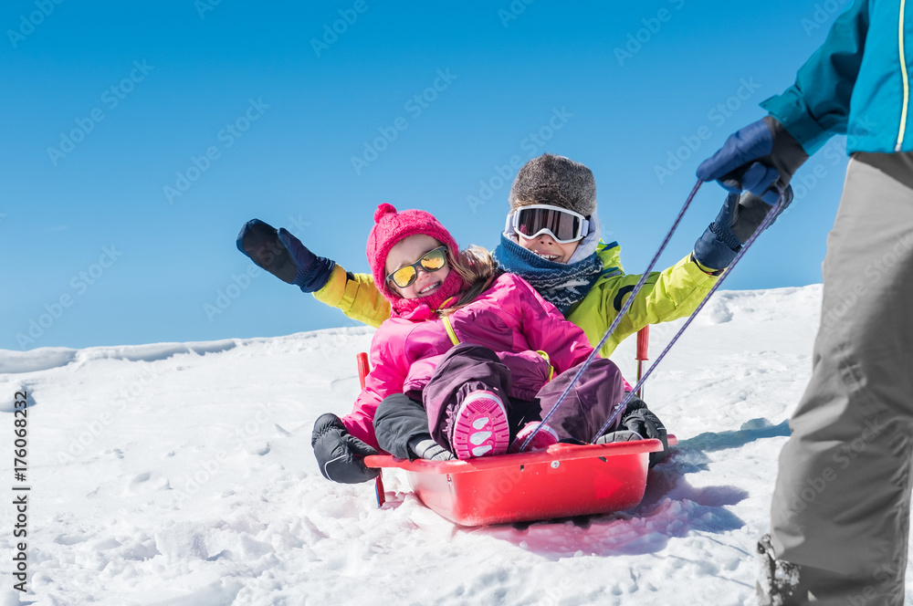 Father playing with children on snow