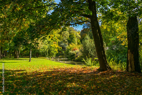 View of the Eisbach river in the English garden park in Munich, Germany, in autumn