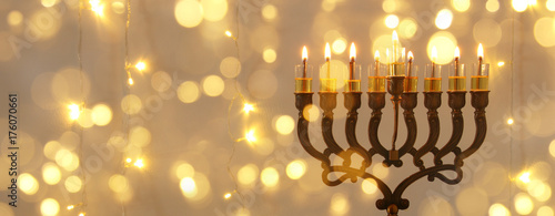 Low key image of jewish holiday Hanukkah background with menorah (traditional candelabra)