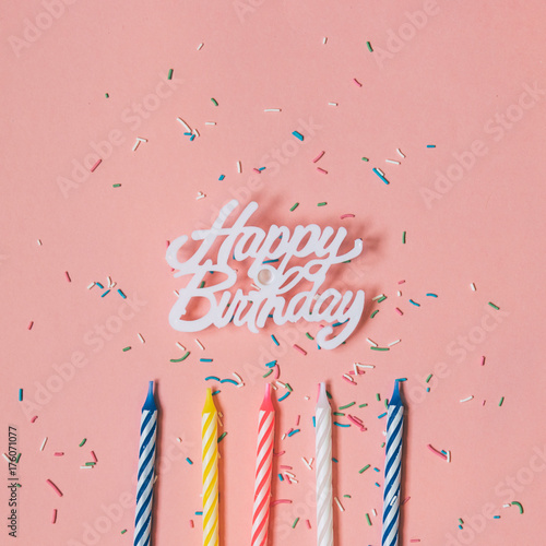 Canvas Print happy birthday, confetti and multicolored candles on a pink background
