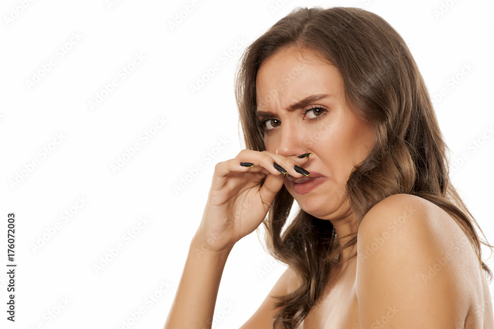 Portrait of beautiful young disgusted woman on white background Portrait of beautiful young disgusted woman on white background