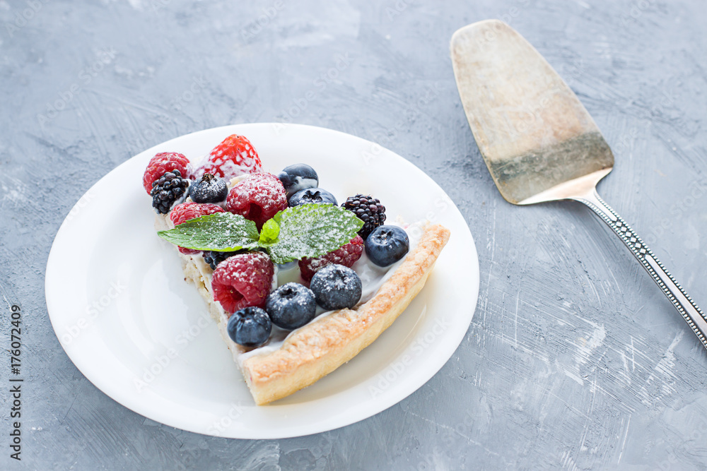 Tart on the plate close up. Homemade dessert with delicious l cream and fresh berries Tart on the plate close up. Homemade dessert with delicious l cream and fresh berries
