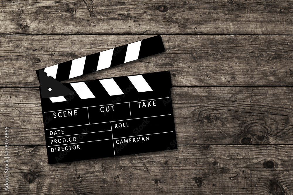 Obraz premium Movie clapperboard on wooden table background.