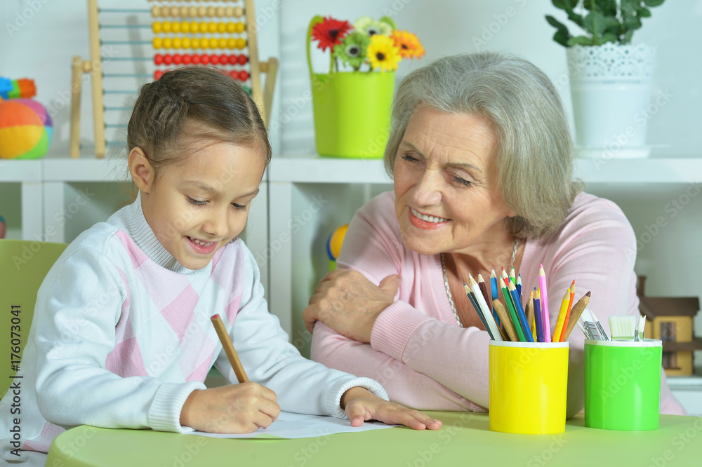 Grandmother with granddaughter drawing together Grandmother with granddaughter drawing together