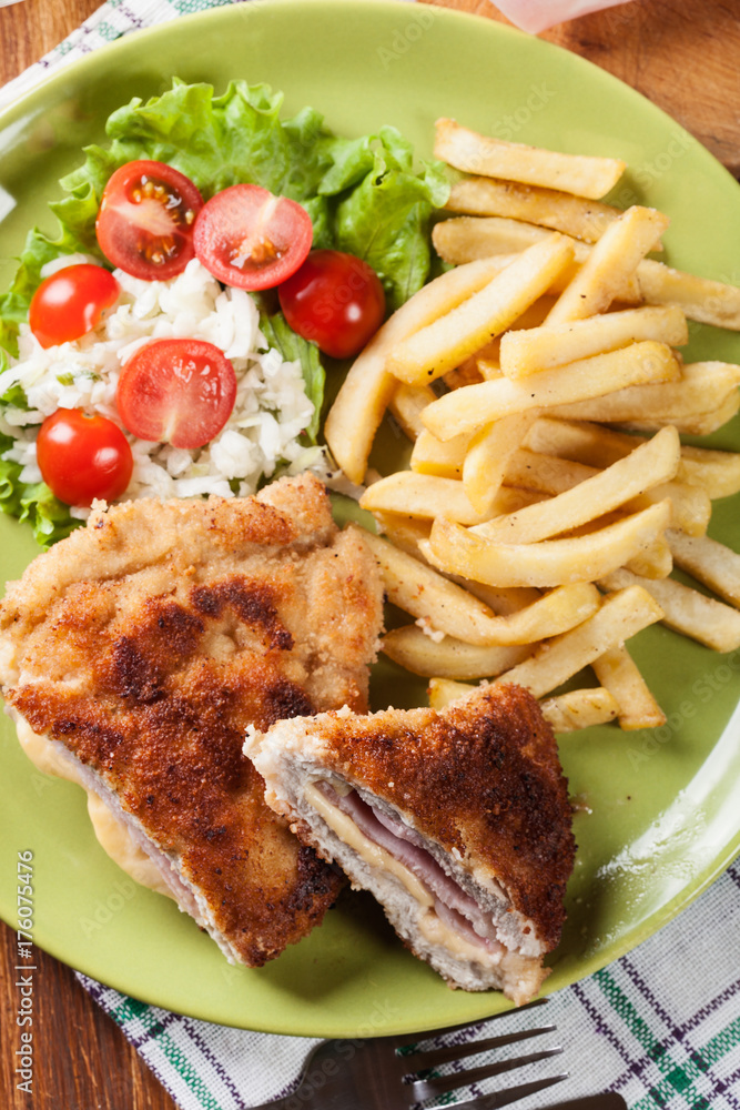 Cutlet Cordon Bleu with pork loin served with French fries and s Cutlet Cordon Bleu with pork loin served with French fries and s