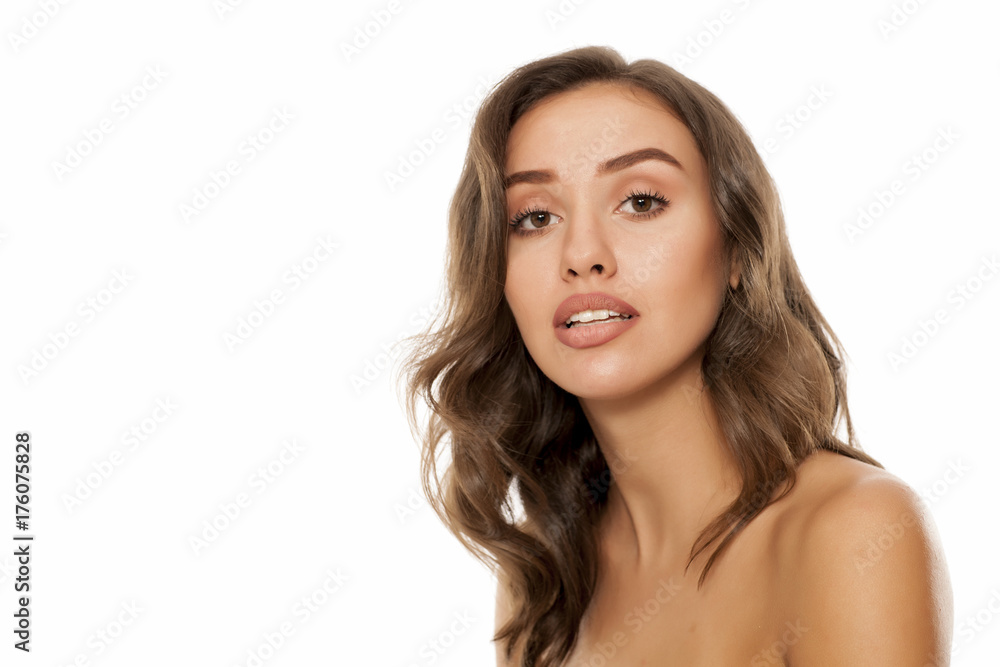 Portrait of beautiful young woman with questionable gesture on white background Portrait of beautiful young woman with questionable gesture on white background