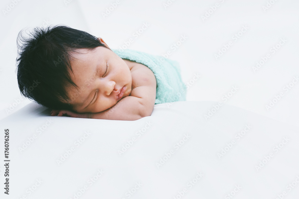 Newborn Baby Sleeping Peacefully Over White Bed Newborn Baby Sleeping Peacefully Over White Bed