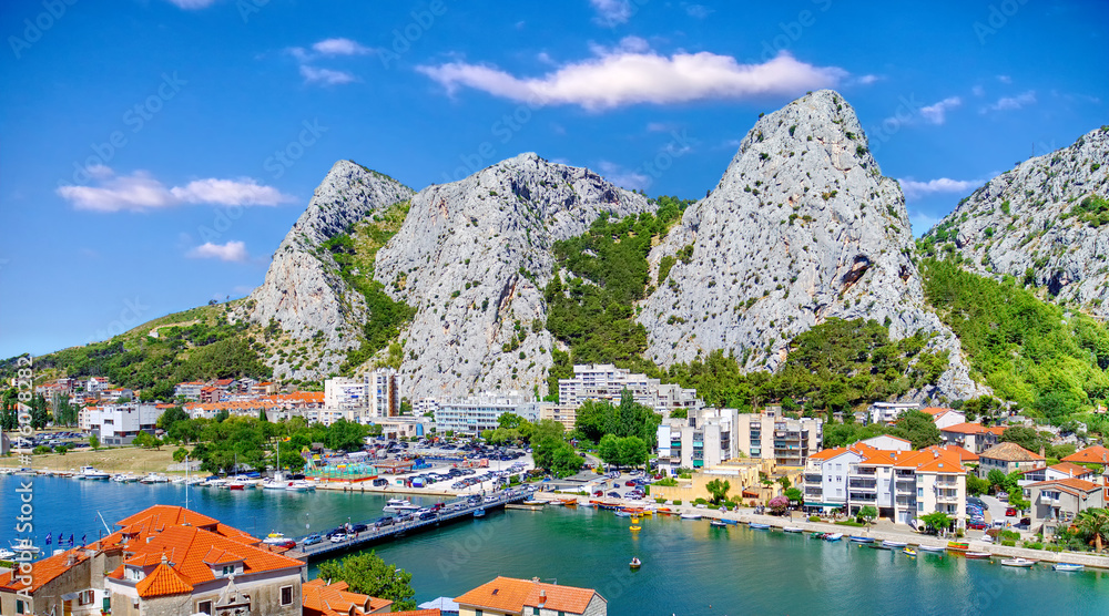 Coastal town of Omis surrounded with mountains in Croatia, Croatian travel landmark at Adriatic sea