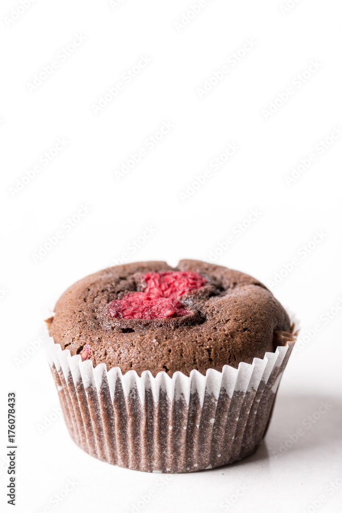 Chocolate cup cake muffin with fresh raspberry isolated on the white background with copy space Chocolate cup cake muffin with fresh raspberry isolated on the white background with copy space