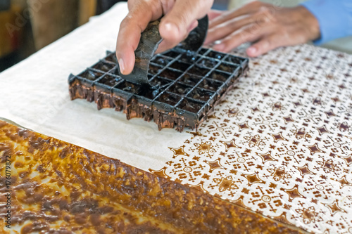 Printing on the fabric to make batik. Batik is part of the indonesian culture. photo