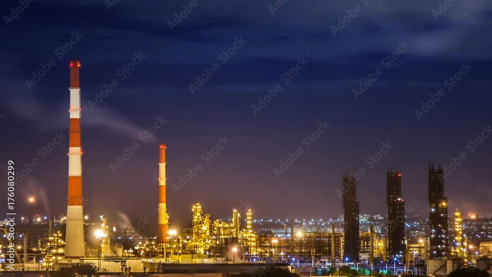 Oil refinery night timelapse with clouds in background. Gas industry background. Oil refinery night timelapse with clouds in background. Gas industry background.