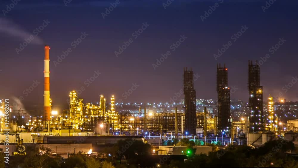 Oil refinery night timelapse with clouds in background. Gas industry background. Oil refinery night timelapse with clouds in background. Gas industry background.