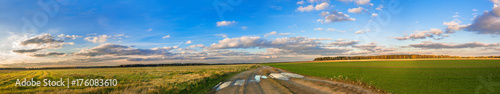 rural autumn landscape panorama with road, field and blue sky