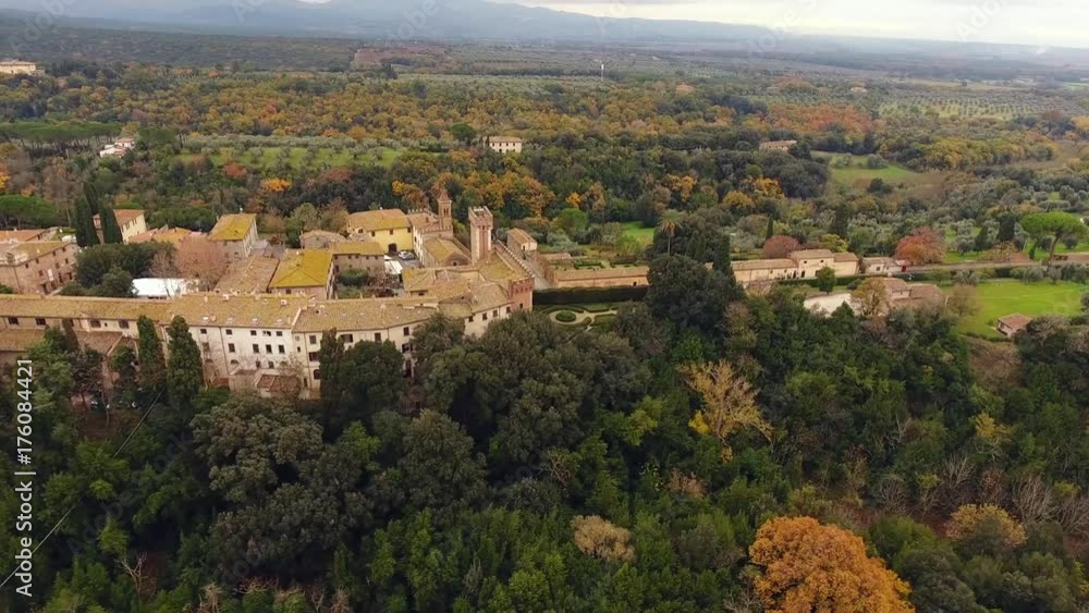 Aerial shot, a small ancient town situated in the middle of rural landscape with cultivated field and a lot of olive trees in Tuscany, Italy, shot with drone Aerial shot, a small ancient town situated in the middle of rural landscape with cultivated field and a lot of olive trees in Tuscany, Italy, shot with drone