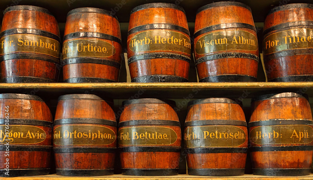 Wood barrels for healing herbs storage. Various names of dried natural plants for example marjoram, parsley, saffron, thyme, rosemary. Herbal medicine or phytotherapy are in wide use around the world Wood barrels for healing herbs storage. Various names of dried natural plants for example marjoram, parsley, saffron, thyme, rosemary. Herbal medicine or phytotherapy are in wide use around the world