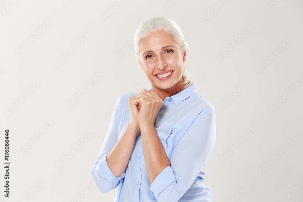 Portrait of exited old woman in blue shirt, looking at camera Portrait of exited old woman in blue shirt, looking at camera