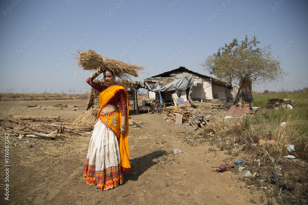 Indian woman wearing yellow clothes working during noon Indian woman wearing yellow clothes working during noon