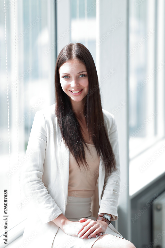 closeup.young business woman standing near the window in the office closeup.young business woman standing near the window in the office