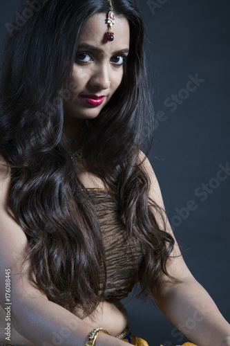 Portrait of young Indian woman wearing ethnic dress with long black hair