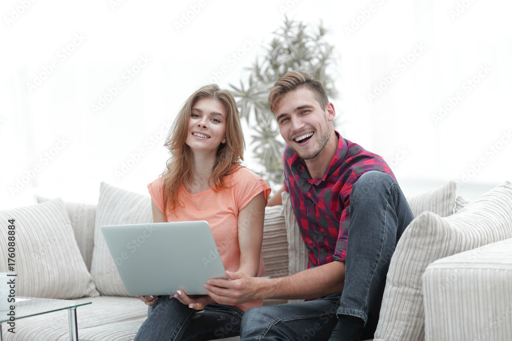 smiling couple resting at home,sitting on the couch. smiling couple resting at home,sitting on the couch.