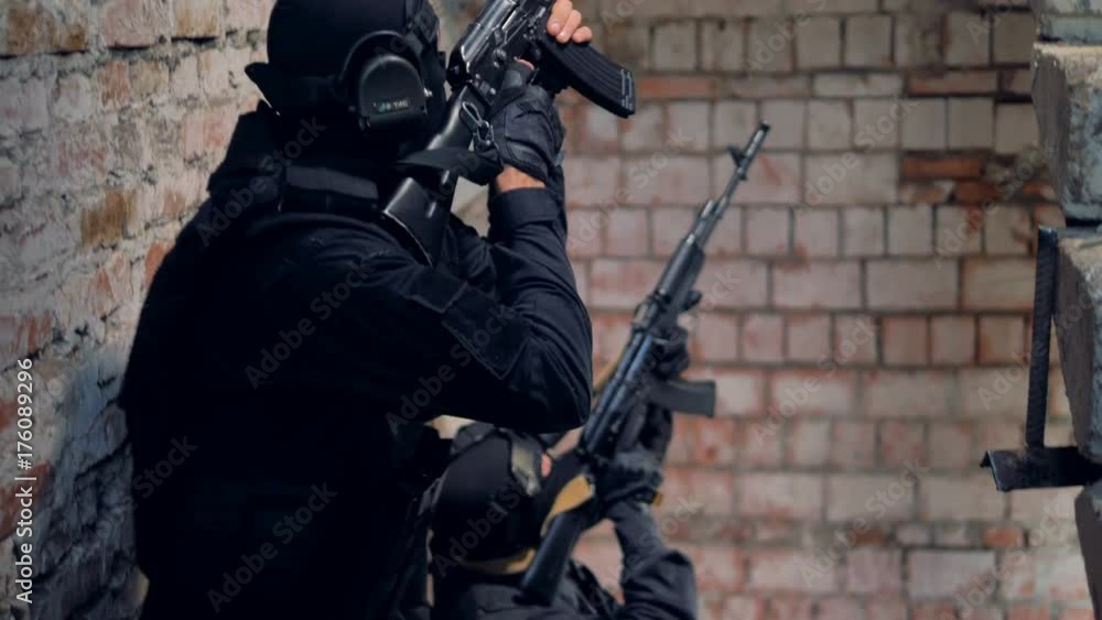 Two man walk up the stairs with aimed guns during hostage release operation. 4K. Two man walk up the stairs with aimed guns during hostage release operation. 4K.