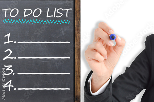 To do list made by businesswoman on chalkboard, business plan and targets of the company for the new year