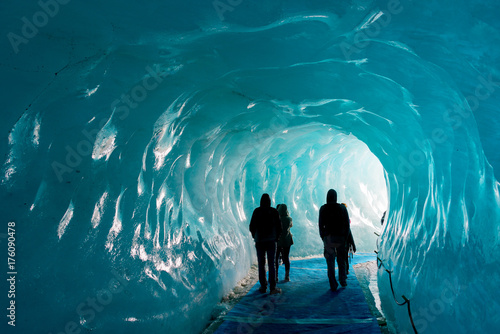Fototapeta Silhouettes of people visiting thee ice cave of the Mer de Glace glacier,  in Ch