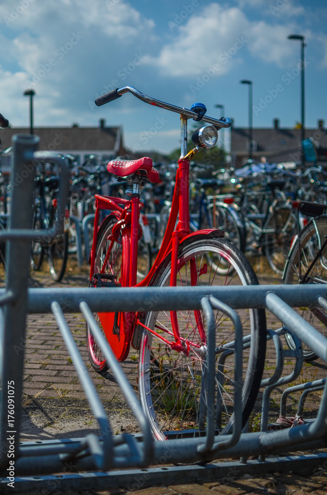 red bike in a bicycle parking rack