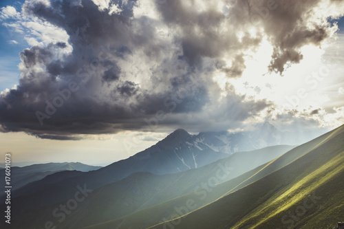 Sunset over green mountains. Landscape from the Tian Shan mountains of Kyrgyzstan.