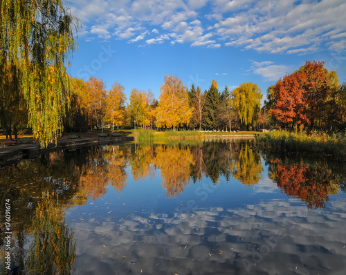 Beautiful autumn park with colorful trees reflected in the water.