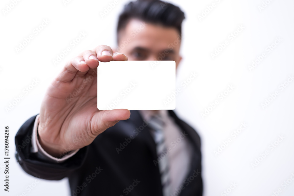 The abstract image of the asian business man hold the mock up credit card and white background is backdrop. The concept of financial, banking, economizing and investment. The abstract image of the asian business man hold the mock up credit card and white background is backdrop. The concept of financial, banking, economizing and investment.